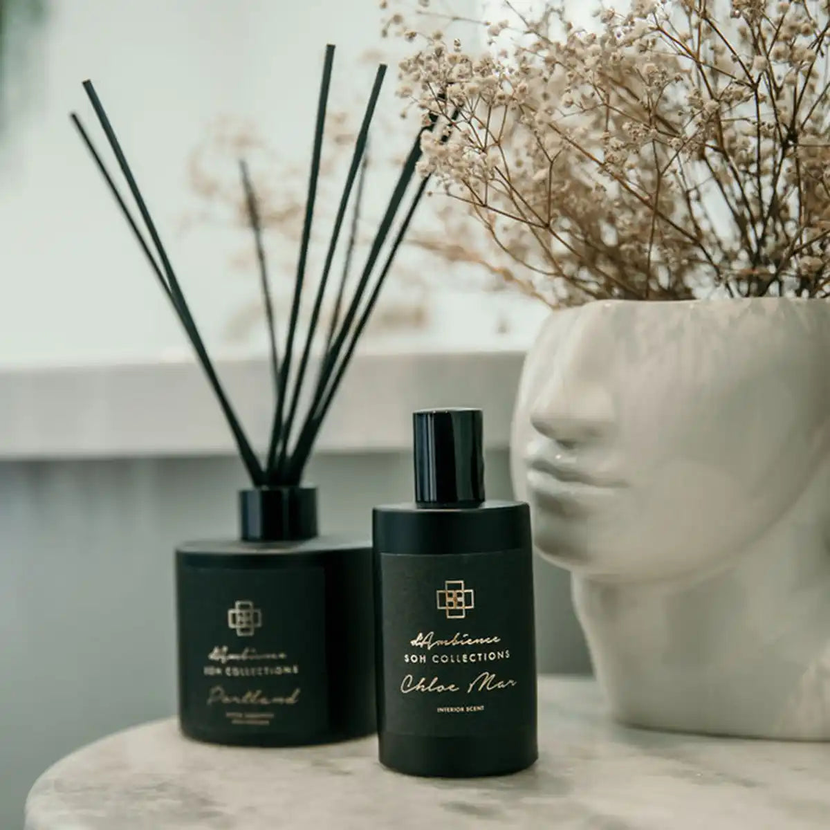 Black diffuser and perfume bottles with a matching design.