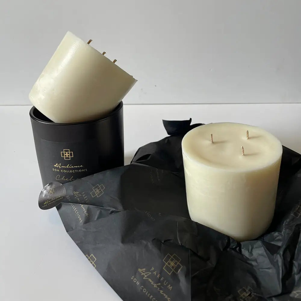 Eco Refill Candle Pod with two three-wick candles in black containers and tissue paper