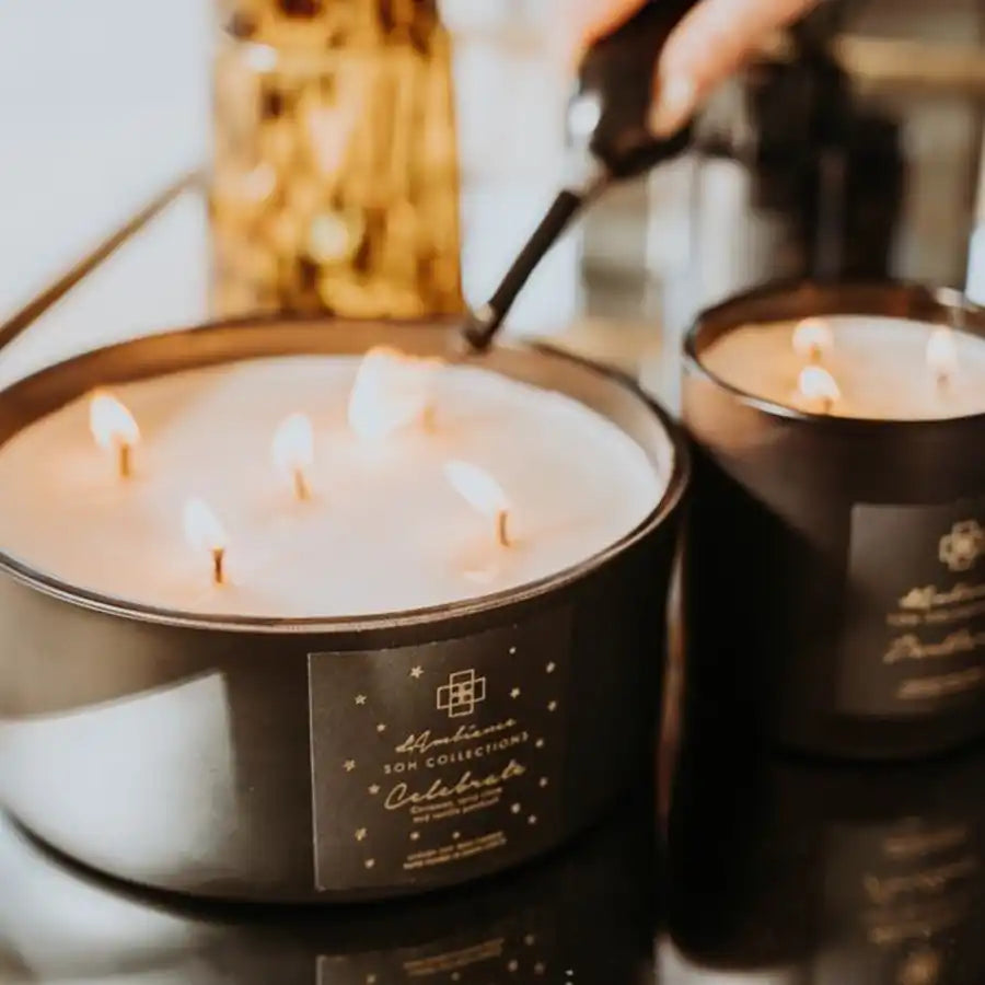 A multi-wick candle in a dark container.