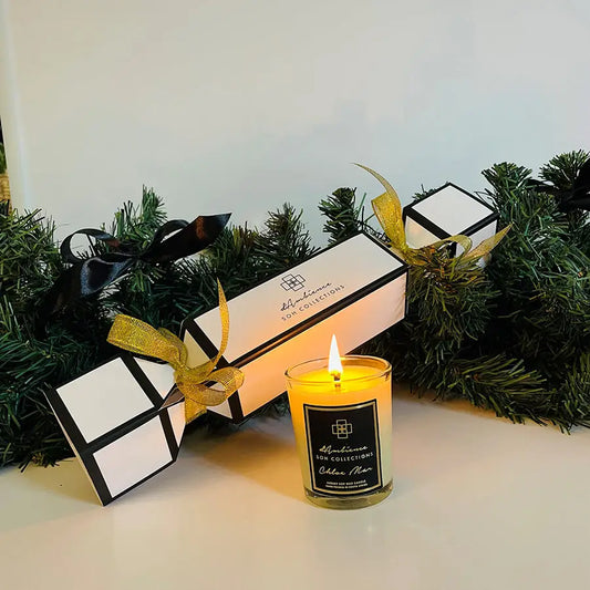 Lit yellow candle in clear glass jar from Festive Cracker scent diffuser collection