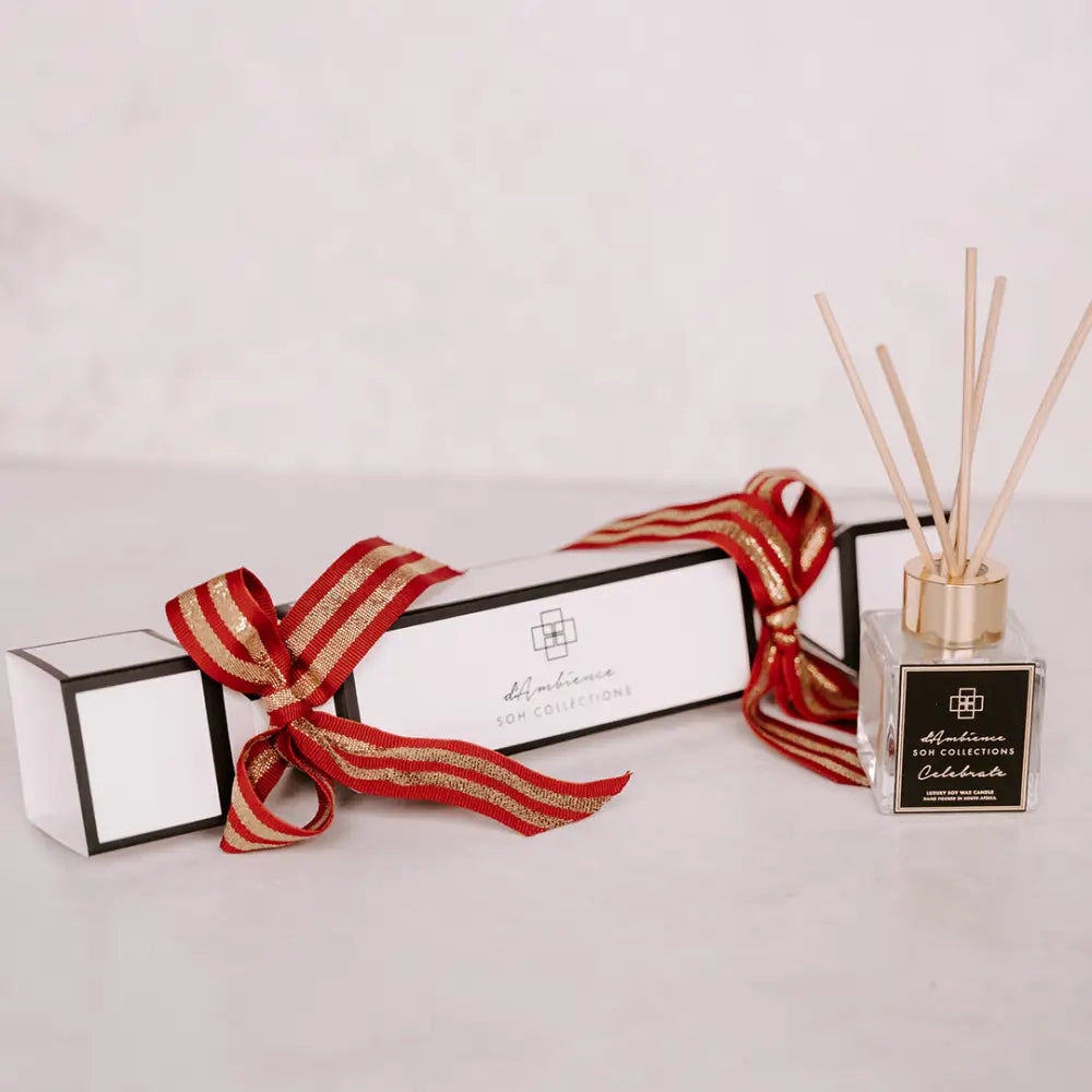 Festive black and white Christmas cracker-shaped gift box with diffuser and reeds