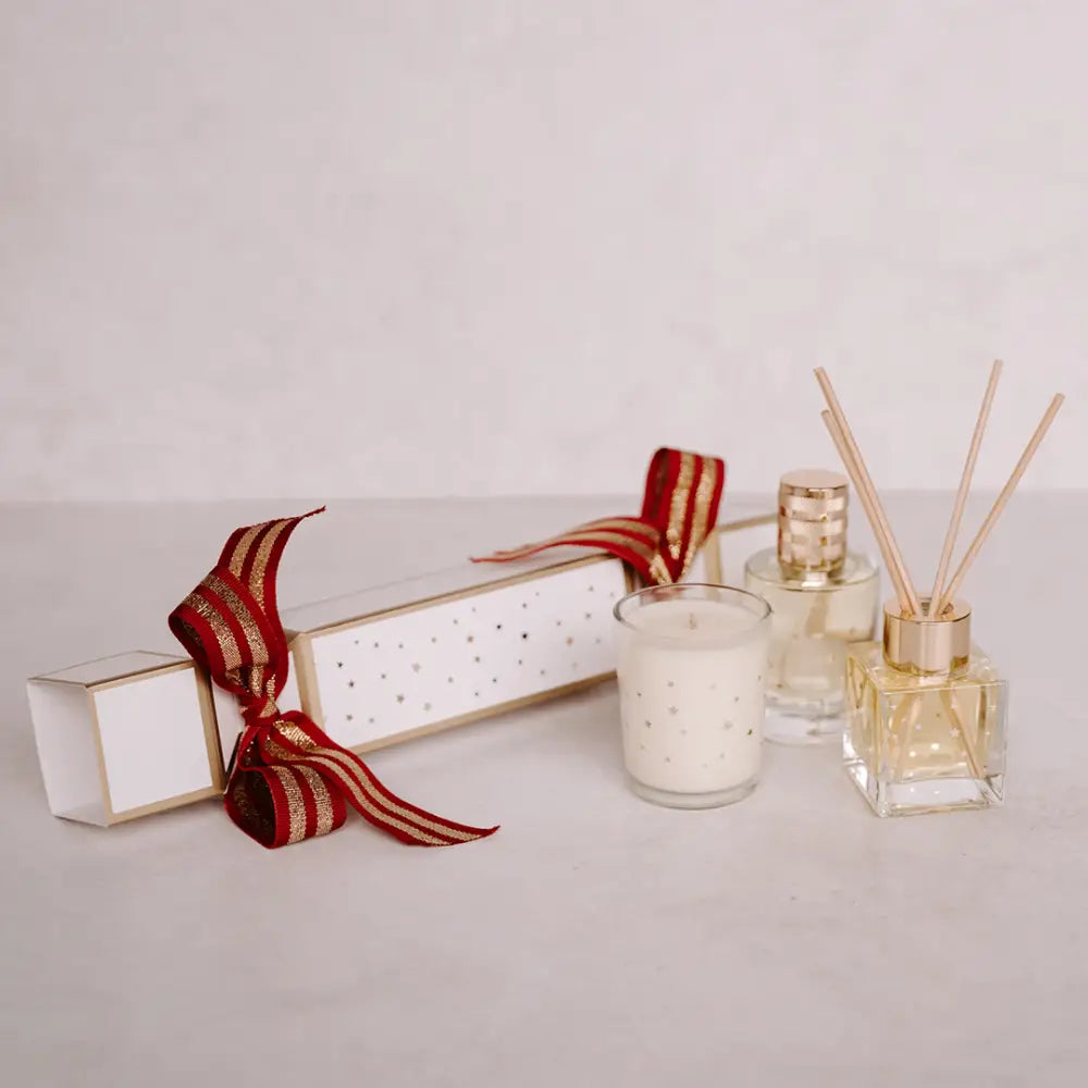 White Christmas cracker with red and gold striped ribbon for festive Christmas celebrations
