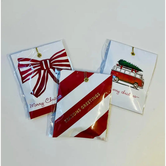 Festive Christmas-themed gift tags in plastic packaging for seasonal diffuser gifts