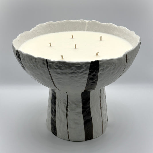 Multi-wick striped ceramic statement candle in textured black and white bowl