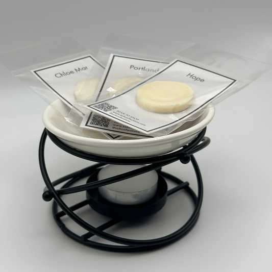 Black metal and white ceramic wax melt burner with packaged matte black wax melts